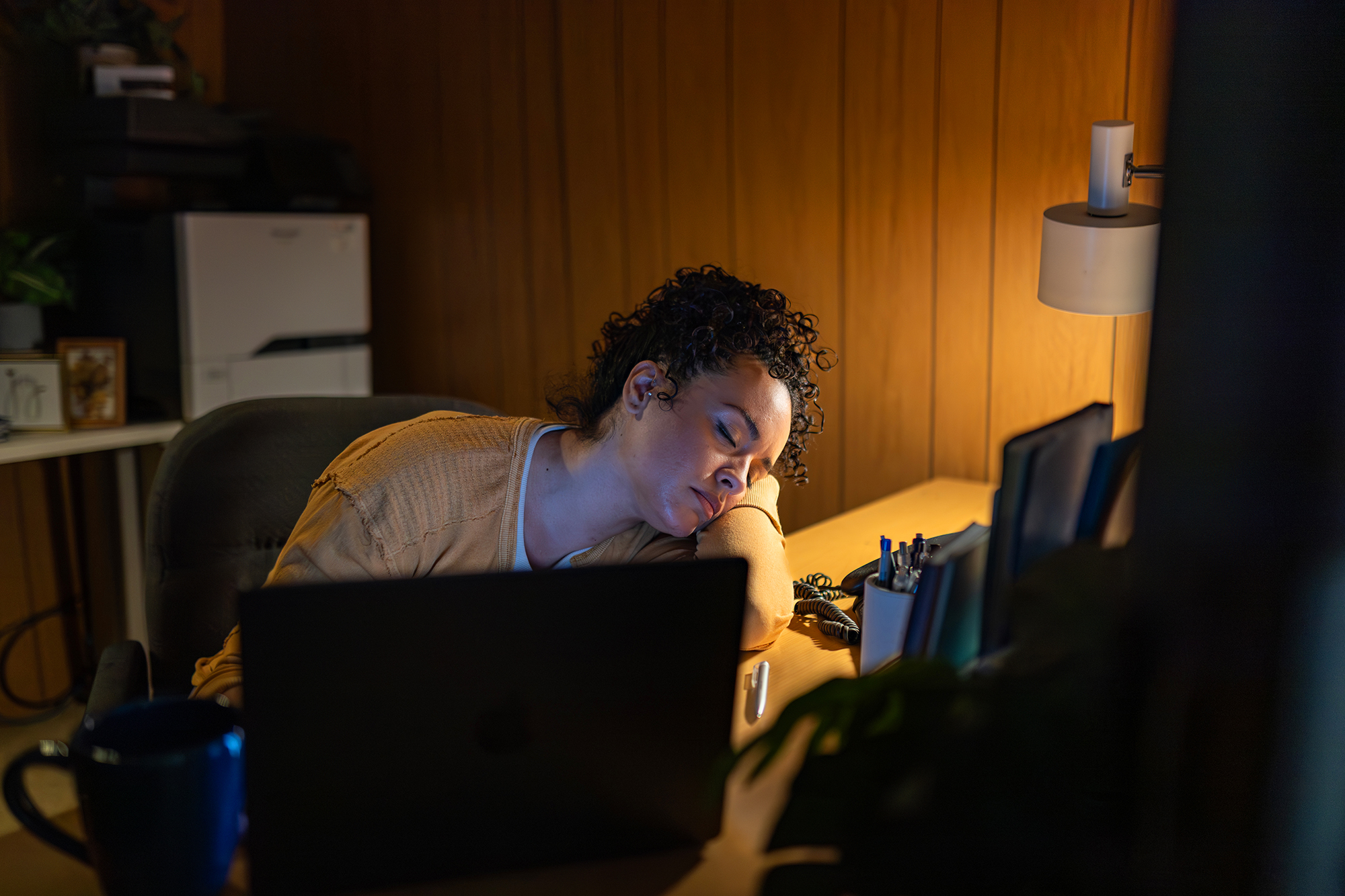 Business owner asleep at desk after trying to build their own website